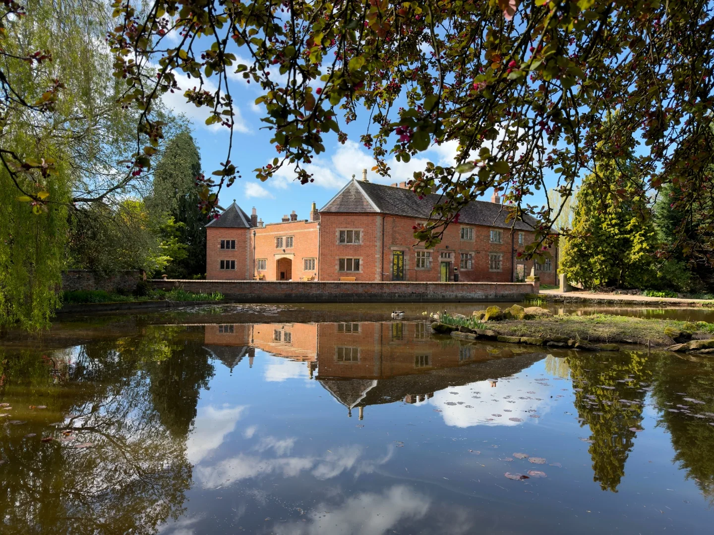 Barton Hall reflected in water